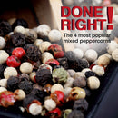 A close-up of a colorful mix of red, black, white, and green peppercorns—done right! The Spice Lab Four Pepper Blend with Grinder 3-Pack features the four most popular mixed peppercorns, perfect for your pepper grinder.