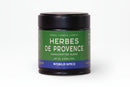 A jar of World Spice Herbes de Provence, featuring a green label and containing 0.63oz (18g) of handcrafted French herbal blend by World Spice, displayed against a white background.