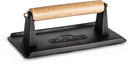 The Napoleon Cast Iron Chef's Press (56056) from Napoleon Grills features a rectangular black cast iron base, a light wooden handle, and embossed branding on top—perfect for even cooking and ideal searing.