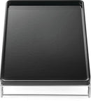 The Napoleon Cast Iron Griddle for Large SIZZLE ZONE® (56082) by Napoleon Grills is a black rectangular griddle with raised edges on a silver wire frame, viewed from above—ideal for flat top cooking.