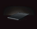The Napoleon Grills Enameled Cast Iron Reversible Griddle for Rogue® 425 (56426), rectangular and black, is shown angled on a dark background with a subtle reflection beneath it.