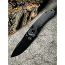 The Spaceman Knives N1 EDC, featuring a textured Micarta handle, lies open on a rough gray stone surface beside a piece of tree bark.