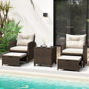 The DirectDeals 5 Pieces Patio Rattan Furniture with 2 Ottomans and Tempered Glass Coffee Table-Red creates a welcoming outdoor conversation area by the pool, surrounded by greenery and glass doors.
