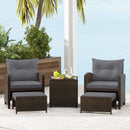 The DirectDeals 5 Pieces Patio Rattan Furniture with 2 Ottomans and Tempered Glass Coffee Table-Red creates a cozy patio seating area with ottomans, stylish chairs, and a table for relaxing by the sea.