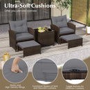 The DirectDeals 5 Pieces Patio Rattan Furniture with 2 Ottomans and Tempered Glass Coffee Table-Red features cushioned chairs, ottomans, and a glass table for a modern outdoor space surrounded by lush greenery.