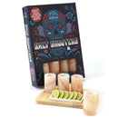 A box labeled The Spice Lab Tequila Himalayan Salt Shooters Gift Set sits alongside four pink Himalayan salt shot glasses on a wooden tray, garnished with sliced lime wedges—the ideal tequila gift set from The Spice Lab for any celebration.