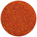 A close-up of The Spice Lab Chorizo Seasoning, a reddish-orange ground spice blend with visible small pieces and granules, displayed in a circular frame on a white background. This vibrant seasoning from The Spice Lab boasts a smoky, savory flavor, making it an ideal all-purpose blend for adding depth to your favorite dishes.