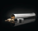 The Napoleon Grills Stainless Steel Smoker Pipe (67011) rests on its side with wood chips spilling out and a round lid nearby, ideal for adding rich smoked flavor to your grill.