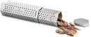 The Napoleon Grills Travel Smoker Tube (67075), made of stainless steel with small holes and a hexagonal lid, sits on a white surface partly filled with wood chips—perfect for adding smoky flavor to your barbecue on the go.
