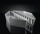 Two angular Napoleon Charcoal Baskets for Kettle Grills (67400) by Napoleon Grills rest on a glossy black surface—one with solid sides, the other with rectangular cutouts for precise heat control.