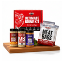 DDR BBQ Supply Ultimate Brine Kit featuring bird brine, AP seasoning, King Craw, and meat bags on a wooden board.