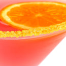 Close-up of a pink cocktail in a glass rimmed with The Spice Lab Zesty Orange Sugar Cocktail Rimmer, its edge perfectly dusted with vibrant orange sugar from The Spice Lab and garnished with an orange slice for the perfect citrus finish.