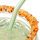 Close-up of a glass rimmed with The Spice Lab Chili Lime Margarita Salt Cocktail Rimmer, filled with a light green iced drink and a green-striped straw.