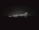 The Napoleon Grills Commercial Grade Rotisserie Kit (69231) for PRO 500 & Prestige® 500 grill models, featuring multiple skewers and a black electric motor, is displayed against a black background with soft lighting.