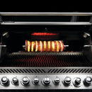 The Napoleon Commercial Grade Rotisserie Kit for Charcoal PRO Grill PRO605CSS by Napoleon Grills cooks layered meat and vegetables, with a glowing heating element above and control knobs on the stainless steel front panel.