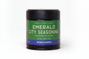 A black jar with a green label featuring World Spice Emerald City Seasoning, Handcrafted Blend, Net Wt. 0.63 oz (18g), World Spice, set against a plain white background. This artisanal seasoning blend from World Spice highlights the unique flavors of the Pacific Northwest, crafted with carefully chosen local ingredients to showcase the region’s bounty.