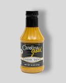 An 18-ounce plastic squeeze bottle of Gourmet Carolina Gold Classic Carolina Gold BBQ Sauce, a mustard-based condiment with a black label.