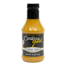 A plastic squeeze bottle of Gourmet Carolina Gold BBQ Sauce with a black cap and label.