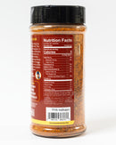 A plastic spice container from Chiles and Smoke holds their Scorching Sun Sweet Heat Rub. It features a black lid and a back label listing nutrition facts, barcode, ingredients, no sugar BBQ rub details, and website information. The container showcases the vibrant reddish-orange spice blend inside, which delivers bold Southwest chile heat—perfect for anyone who loves a spicy BBQ rub.