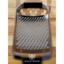 A close-up of the Dalstrong Professional Coarse Wide Cheese Grater with a durable G10 handle, featuring small, sharp holes and the DALSTRONG logo at the bottom, resting on a wooden surface.