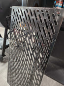 a close-up view of a metal grate or screen with a perforated pattern, likely used for ventilation or filtration purposes.
