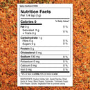 A nutrition label for The Spice Lab Spicy Seafood Seasoning rests on a textured background of red and orange spice mix, listing ingredients and nutritional info per 1/4 teaspoon serving. Ideal for coastal cooking, this Cajun-inspired blend from The Spice Lab adds bold flavor and heat to any seafood dish.