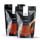 Two black bags of The Spice Lab Chorizo Seasoning are displayed, each featuring a wooden spoon and a pile of red spice on the front. This all-purpose seasoning from The Spice Lab is celebrated for its smoky, savory flavor, carries the label No. 7019, and comes in a 2 lb net weight.
