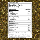 A nutrition facts label for The Spice Lab Salt Free Salmon Seafood Seasoning is displayed over a background of mixed dried herbs. The label includes information on calories, fat, carbohydrates, protein, sodium, and ingredients like dill weed, black pepper, and dehydrated garlic.