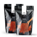 Two black pouches of The Spice Lab All-Natural Taco Seasoning, each displaying an image of smoky taco seasoning being scooped with a wooden spoon. The pouches are marked No. 7051 and have a net weight of 2 lb each.