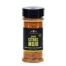 A clear plastic jar labeled The Spice Lab Spicy Citrus Mojo Seasoning contains 5.7 oz (161g) of a reddish spice blend with a vibrant citrus flavor, making it an ideal and versatile dry rub for meats, fish, and vegetables.