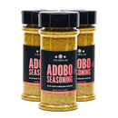 Three bottles of The Spice Lab Adobo Seasoning are grouped together, each featuring black lids and labels with pink and white text. Each 4.5 oz (127g) bottle contains this versatile all-purpose seasoning from The Spice Lab, ideal for adding bold Latin-inspired flavor to your favorite dishes.