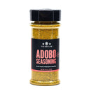 A clear plastic spice jar containing yellow-brown The Spice Lab Adobo Seasoning, featuring black and red packaging and a net weight of 4.5 oz (127g). This all-purpose seasoning from The Spice Lab brings vibrant Latin-inspired flavor to your favorite dishes.