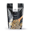 A black and white resealable bag labeled The Spice Lab Everything and More Seasoning by The Spice Lab, featuring an image of a wooden spoon scooping a colorful spice blend. This all-purpose seasoning combines savory garlic and onion flavors, evoking the taste of classic everything bagel seasoning. Net weight: 2 lb.