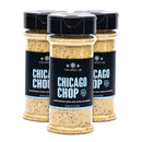Three bottles of The Spice Lab Chicago Chop Seasoning, featuring black labels, are arranged in a triangular formation against a white background. This seasoning blend from The Spice Lab brings an irresistible smoky steakhouse flavor, enhanced with notes of savory hickory smoke in every sprinkle.