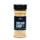 The Spice Lab Chicago Chop Seasoning is packed in a clear plastic jar with a black lid and features a vibrant yellow blend. Labeled with The Spice Lab brand, this seasoning delivers an authentic smoky steakhouse flavor with a touch of hickory smoke—ideal for enhancing your favorite meats and vegetables.