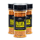 Three bottles of The Spice Lab Fajita Seasoning, featuring black caps and labels with yellow text, are arranged in a triangular formation on a white background—ideal for adding bold Tex-Mex flavor to your favorite chicken fajitas.