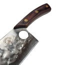 The Spaceman Knives Meteor Series Kitchen Cleaver features a textured stainless steel blade and a wooden handle with brass rivets, shown on white marble with a black cloth in the background—ideal for chopping meat.
