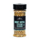 A clear plastic jar labeled The Spice Lab Mont Royal Steak Seasoning, from The Spice Lab, featuring a black lid and a blue-accented label, contains a classic Montreal-style BBQ spice blend.