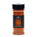 A clear plastic bottle of The Spice Lab Mexican Street Corn Seasoning with a black cap and label. The label describes the seasoning as savory, smoky, and a little bit spicy—perfect for adding authentic Elote flavor to your favorite dishes.