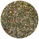 A close-up view of The Spice Lab Chimichurri Seasoning by The Spice Lab, showcasing a finely chopped blend of green leaves, red pepper flakes, and assorted spices spread evenly within a circular frame—ideal for crafting an authentic Argentine chimichurri flavor.