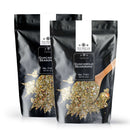 Two black pouches labeled The Spice Lab Guacamole Seasoning, each featuring a white label and an image of a wooden spoon filled with seasoning on the front. These pouches contain a flavorful spice mix from The Spice Lab, ideal for enhancing guacamole, avocado toast, or any keto-friendly recipe.