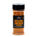 A clear plastic spice jar labeled “The Spice Lab Rotisserie Chicken Seasoning,” filled with reddish-brown seasoning that adds a rich roasted chicken flavor and golden color to dishes, is shown against a white background.
