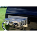 Close-up of a WPPO Traditional 25" Dual Fueled Pizza Oven With Gas Attachment by WPPO LLC Direct, attached to the side with a visible control knob and gas connection, set against a grassy background.