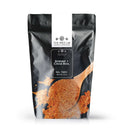 A black resealable bag labeled The Spice Lab Shrimp + Crab Boil Seasoning features an image of a wooden spoon filled with orange-red seafood seasoning, partially spilled onto the surface. This seasoning from The Spice Lab delivers medium heat and is available in a 2 lb net weight.