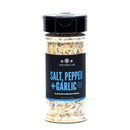 A clear spice jar of The Spice Lab Salt, Pepper + Garlic Seasoning features a black label with blue and white text, and is filled with a coarse blend of salt, pepper, and garlic—an ideal addition to your daily seasoning collection.