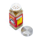 A glass spice jar filled with a brownish powder labeled “The Spice Lab Nom Nom Paleo Magic Mushroom Powder” sits on a white surface, its perforated metal lid resting beside it. The label from The Spice Lab showcases ingredients like porcini mushroom and highlights this savory umami seasoning blend.