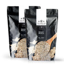 Two black resealable pouches of The Spice Lab Smoky Maple Seasoning from The Spice Lab, each labeled No. 7237 and Net Wt. 2 lb, with a wooden spoon scooping the sweet and savory seasoning featured on the packaging.