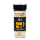 A clear spice jar labeled The Spice Lab Smoky Maple Seasoning by The Spice Lab, with a black lid, contains a sweet and savory seasoning blend. The label indicates it’s perfect for salmon, pork, chicken, and vegetables.