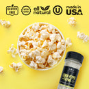 A bowl of popcorn and a bottle of The Spice Lab Lemon Pepper + Thyme Seasoning sit on a vibrant yellow background. Labels above read: gluten free, non-GMO, all natural, certified kosher, made in USA.
