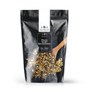 The Spice Lab Pizza Dust Seasoning comes in a black resealable pouch featuring an image of a wooden spoon with red and yellow spice flakes. This savory seasoning from The Spice Lab delivers bold, pizza-inspired flavor to your favorite dishes.